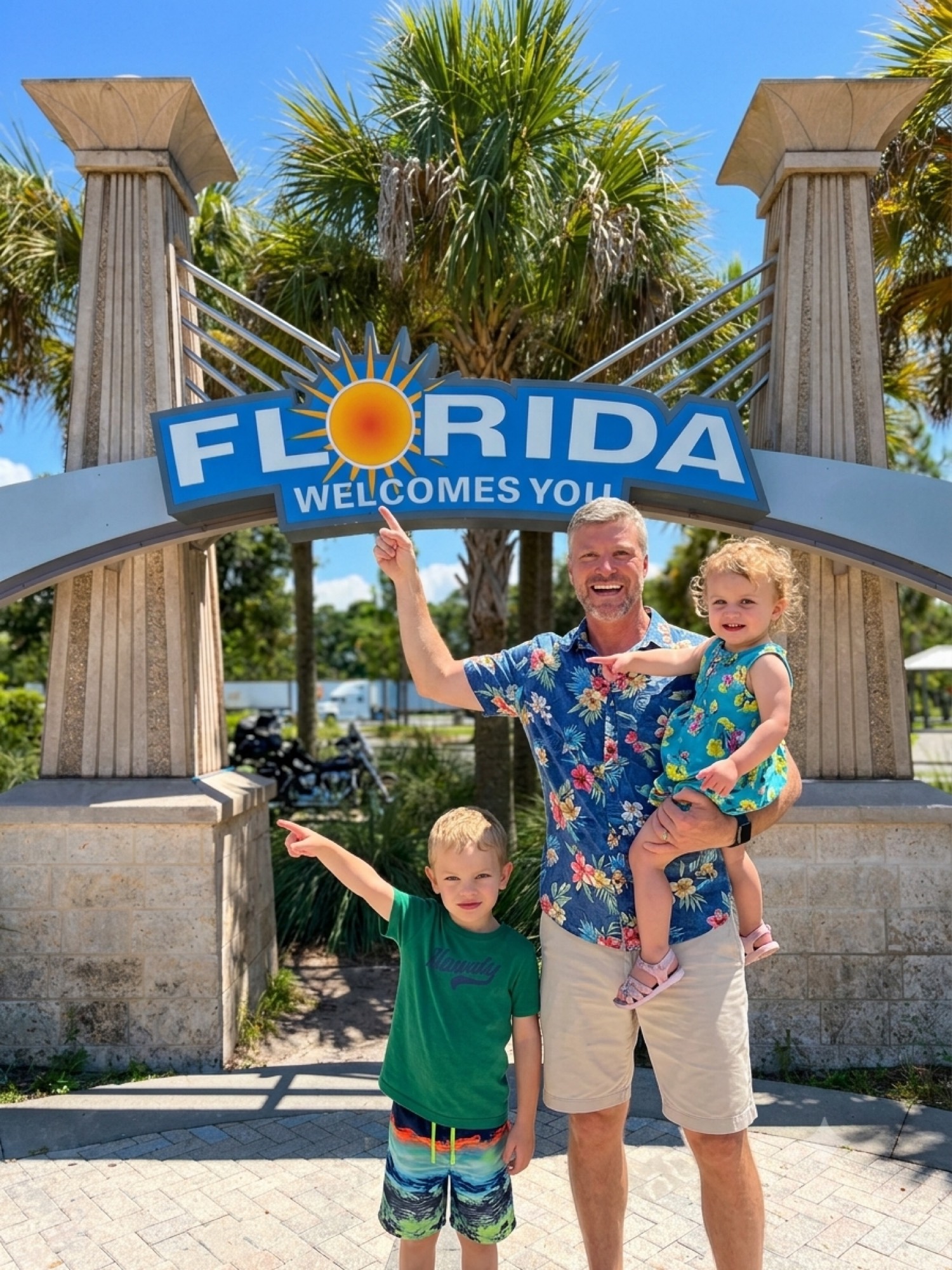 Neal Chambers and family at the Florida Welcomes You sign