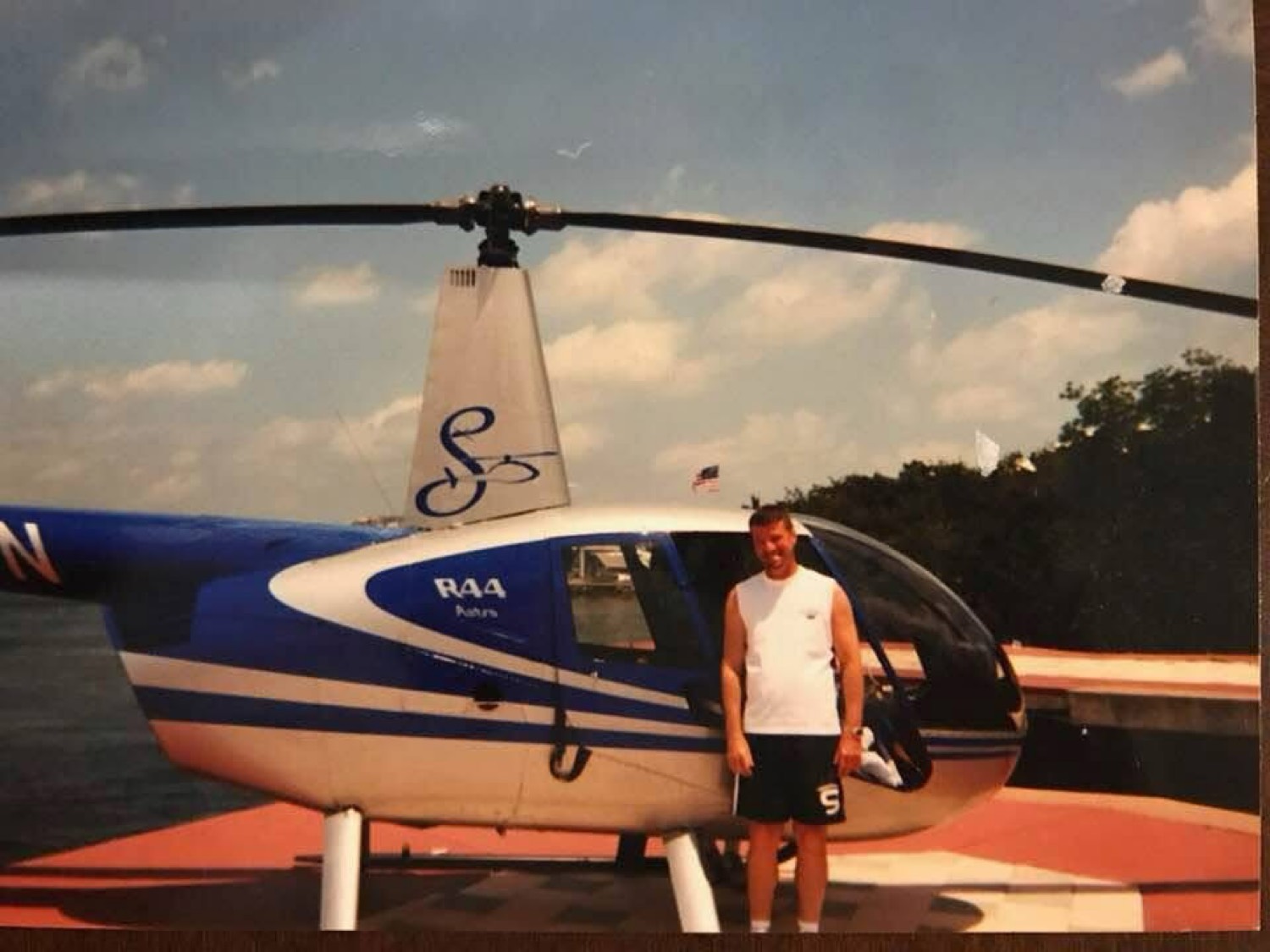 Neal Chambers, licensed pilot, with helicopter